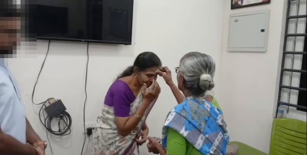 A volunteer greeting a resident at an elderly home