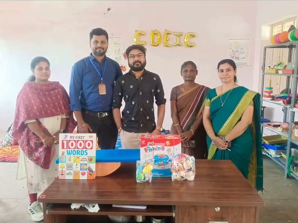 Volunteers handing over therapy materials
